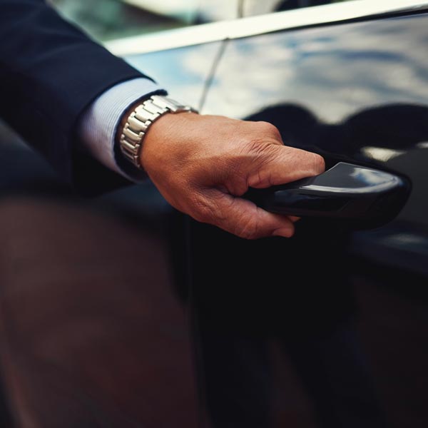 Chauffeur Service Milan: driver opens the door