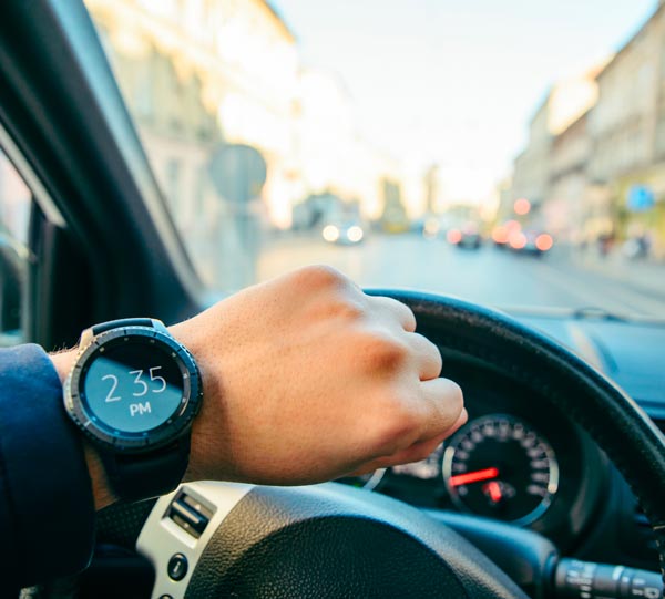 Chauffeur Service Milan: man looking at the clock inside the car
