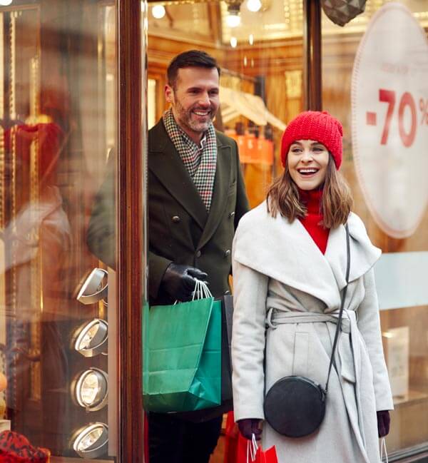 Enjoying Christmas in Milan in a Luxury Car with Driver: Couple buying in shops