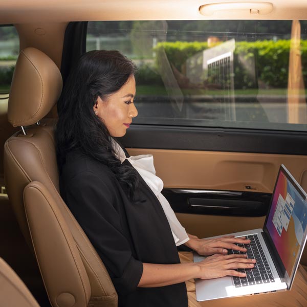Hire a chauffeur driven car Milan: Vip Limousine Takes You to MIMO Hire a chauffeur driven car Milan: business woman inside a car