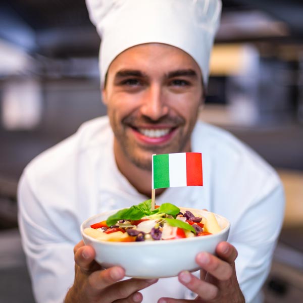 Hire Car with Driver Milan: Handsome chef presenting meal with Italian flag