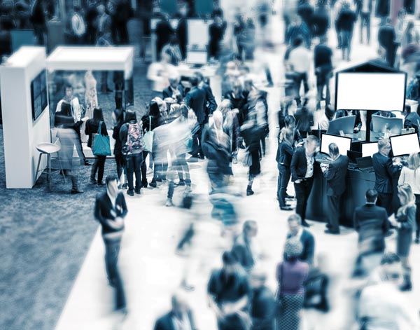  Transfer Milan and long range transfer: View of the blurred crowd on an exhibition with trade fair stands